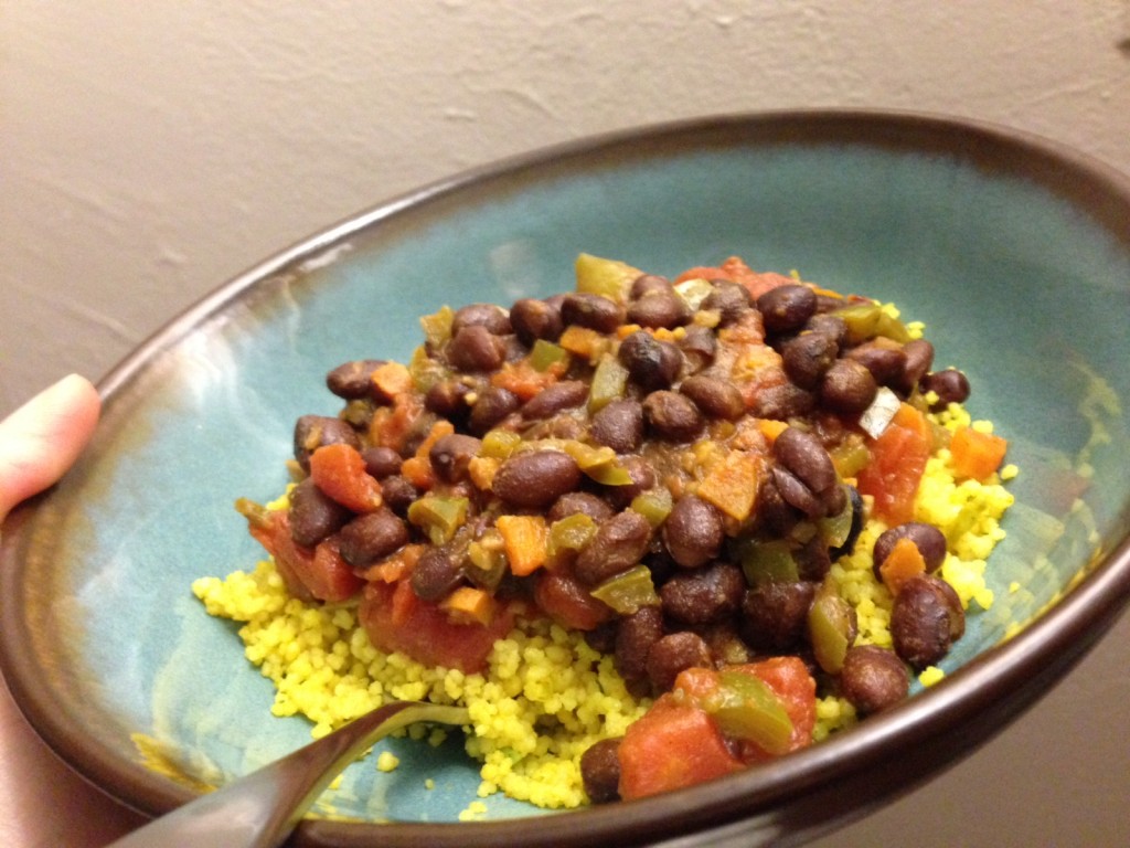 Serena cooks black bean curry with couscous.