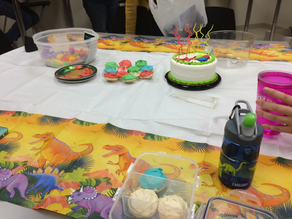 Erin's co-workers surprise her with a dinosaur-themed party.