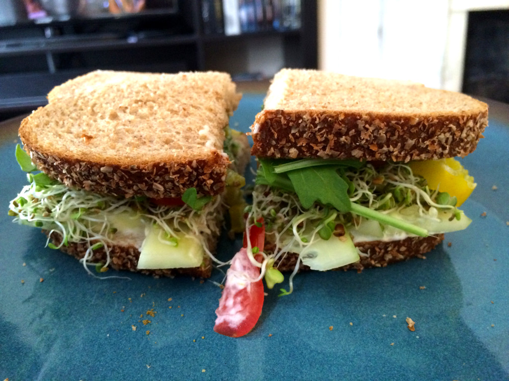 Erin makes a sandwich with veggies grown by Stacy!