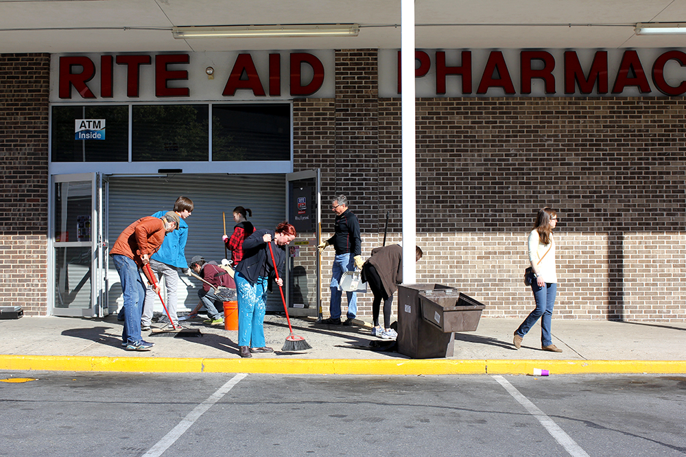 Neighbors clean up our local pharmacy after looting in our neighborhood.